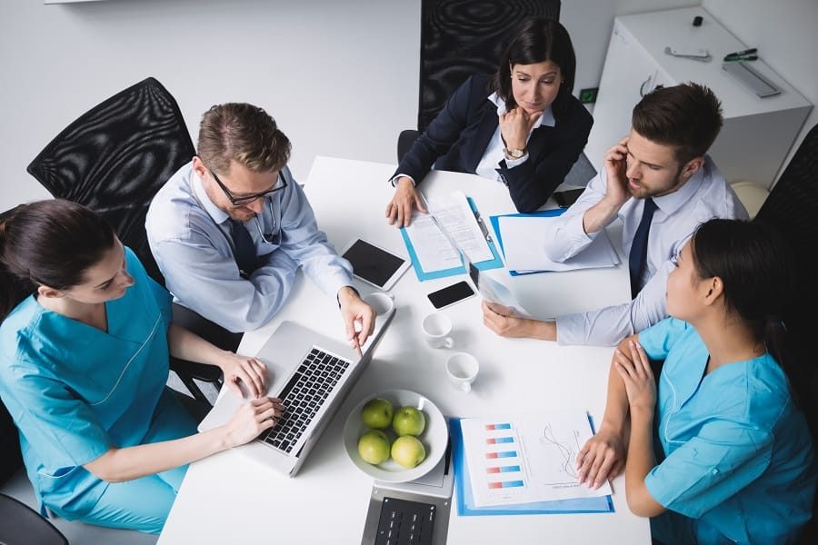 Healthcare professionals in a team meeting undertaking process mapping.