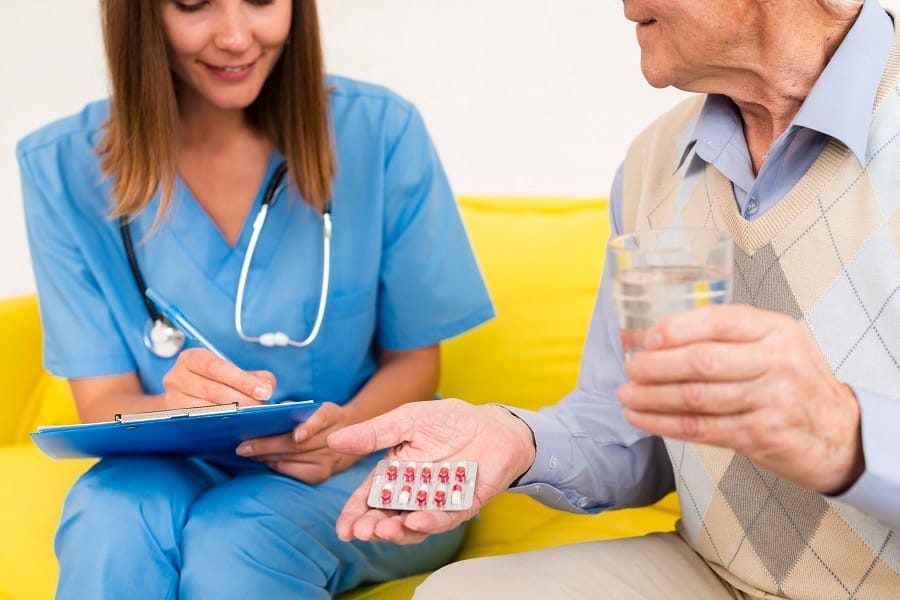 nurse and resident discussing medication.